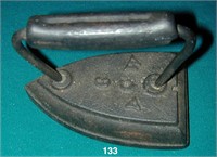 Sad iron with integral iron handle has initials AC
