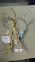 7 Bolo ties and a shell pendant