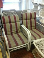 Pair of white cushioned outdoor chairs with