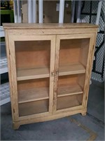 Blonde cabinet with glass doors
