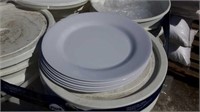 bucket of white plastic plates