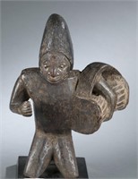 Kneeling Yoruba drummer. 20th century.