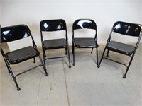Four Black Metal Folding Chairs