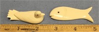 2 - 2 1/2" ivory carvings with baleen eyes, one is