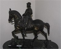 Bronze sculpture of a man and horse