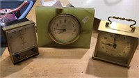 Three vintage table clocks, one electric green