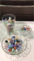 Vintage marbles in three pieces of glassware
