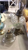 Two antique glass base oil lamps , one with