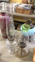 Two antique glass oil lamps one with a tall shade