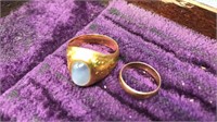 Two gold tone rings one has a stone in it the