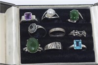 Nine various silver rings in a box