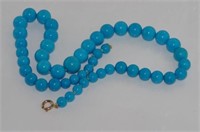 Gradated blue stone necklace with 9ct gold clasp