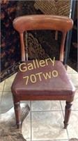Antique wood chair with a leather seat