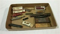 An assortment of pocket knives, straight razor,