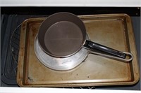 CONTENTS OF DRAWER UNDER STOVE: BAKEWARE AND