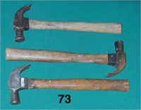 Three assorted claw hammers with wooden handles