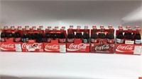 SIX COCA COLA 6 PACKS AND BOTTLES