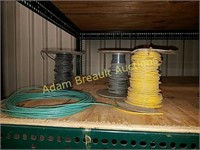 Three partial spools coated assorted wire
