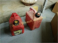 Two small plastic gas cans