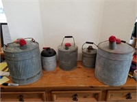 C- GALVANIZED FUEL AND OIL CANS.