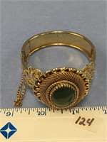 Gold tone bangle bracelet, hinged with safety chai
