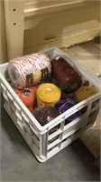 Plastic crate of new rolls of rope or cord in