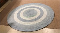 Large room size blue braided rug, measures 84