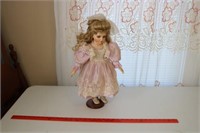 Doll with Purple Lace Dress on Wooden Stand