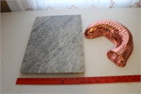 A Marble Cutting Board and a Fish Mold
