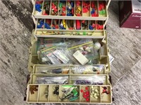 A Plano plastic fishing tackle box filled to the b