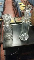 Pair of unique glass bottles with stoppers