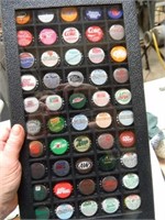 NEAT COLLECTION OF SODA BOTTLE CAPS IN A DISPLAY