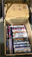 Box lot of 33 DVDs in a stack of shelf trays made
