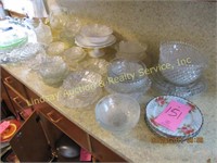 Large group of glass dishes: plates, bowls, cups,