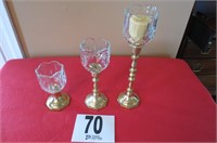 3 gold candle sticks with glass votives.