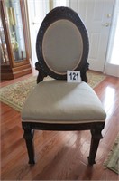Ornately carved wood chair w/cloth covered