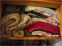 Large group on 2 shelves full of towels, cloths &