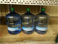 (3) plastic 5 gallon water jugs, 1 full, 2 empty
