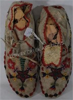 PAIR OF BEADED MOCCASINS ON HIDE WITH HIDE LACES,