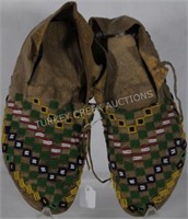 PAIR OF BEADED HIDE MOCCASINS WITH HIDE LACES.
