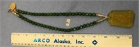 Approx. 26" jade bead necklace with a religious pe