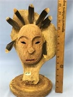 Carved wood mask mounted on an ancient flipper bon