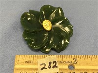 A 2" x 2" jade pin with a 1/4" sized gold nugget