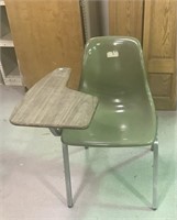 Molded plastic chair with desk arm