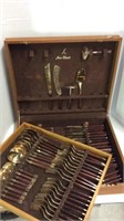 BRASS AND WOOD FLATWARE SET IN CASE