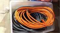 Tub lot with a orange air hose with brass fitting