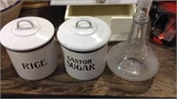 Two black and white enamel kitchen canisters with