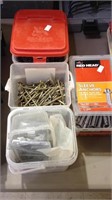 Three boxes of screws and a box of sleeve anchors