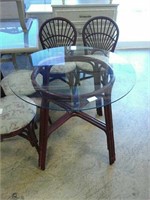 Small round glass top table with wooden legs and