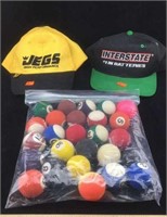 Two Baseball Caps and a Bag of Rubber Balls